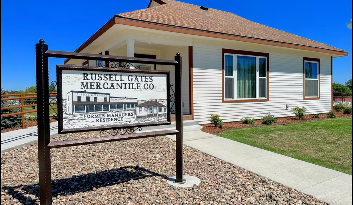 An image with a sign in front that reads Russell Gates Merantile CO. Former Managers Residence